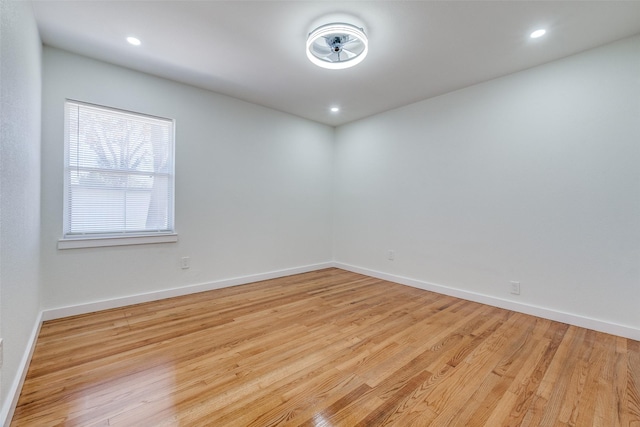 empty room with light hardwood / wood-style flooring