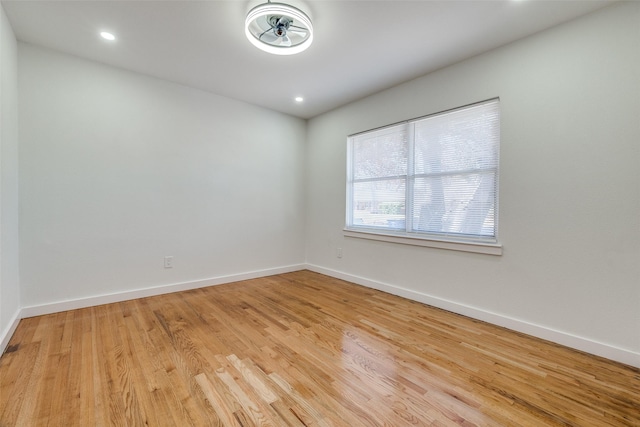 spare room featuring light wood-type flooring and ceiling fan