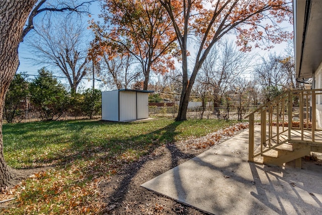 view of yard featuring a shed and a patio area