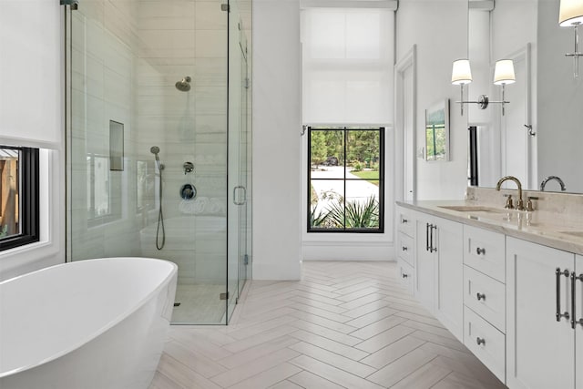 bathroom with vanity, parquet flooring, and separate shower and tub