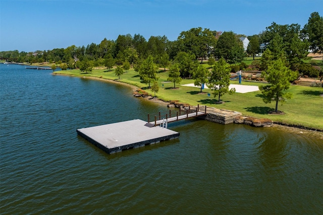 view of dock with a water view and a yard