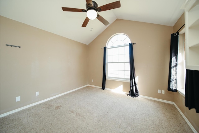 carpeted spare room with lofted ceiling and ceiling fan