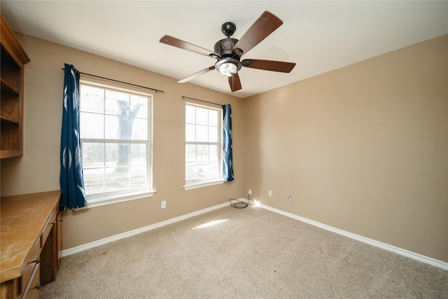 carpeted empty room with ceiling fan