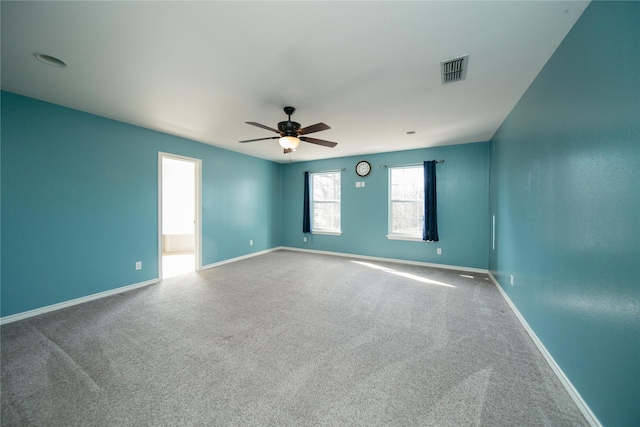 spare room featuring ceiling fan and carpet