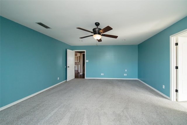 carpeted spare room with ceiling fan