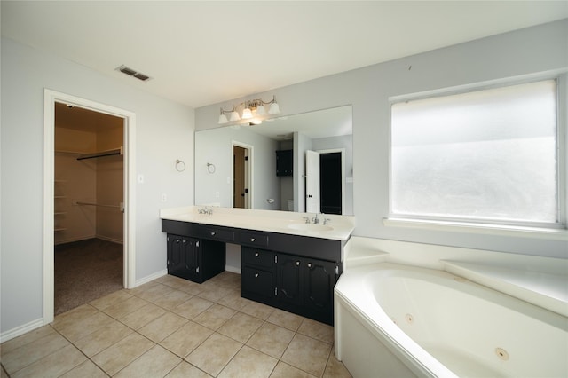 bathroom featuring vanity, a bathing tub, and tile patterned floors