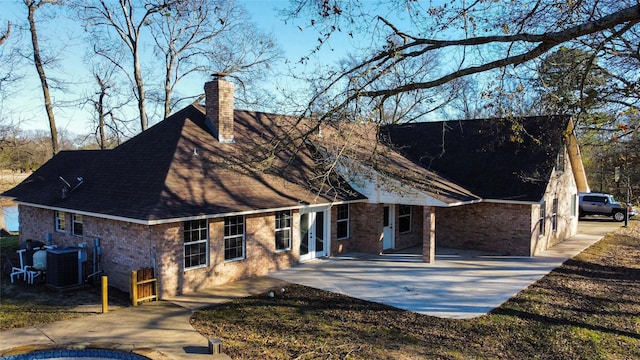 back of property with a patio area and central air condition unit