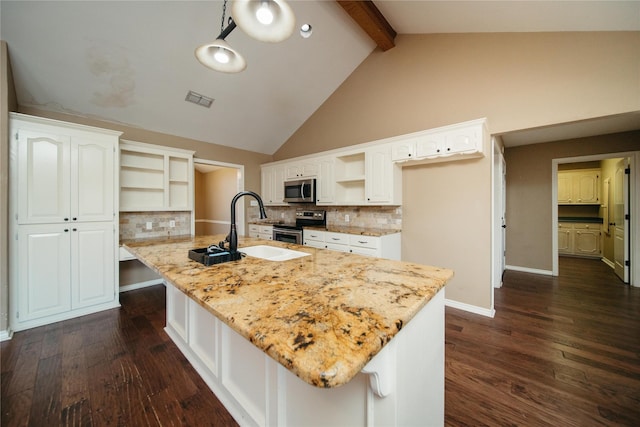 kitchen with a kitchen island with sink, appliances with stainless steel finishes, sink, and white cabinetry