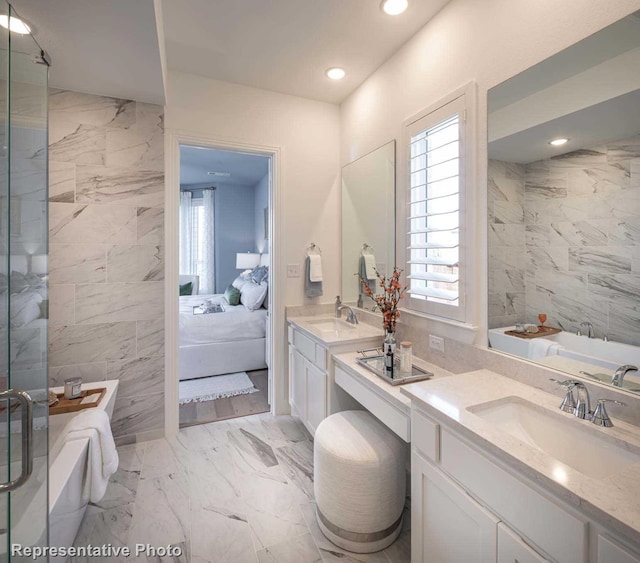 bathroom with shower with separate bathtub and vanity