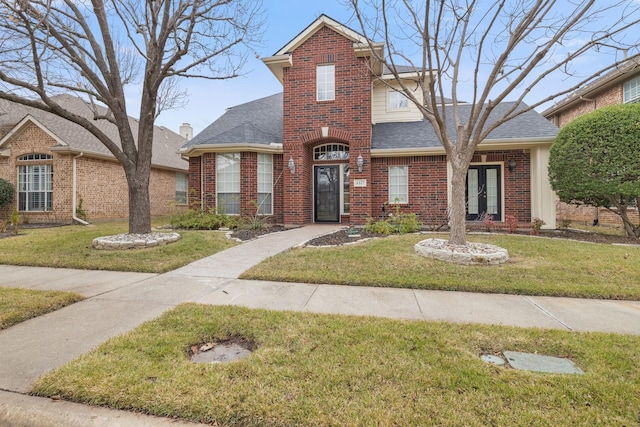 view of property featuring french doors and a front yard