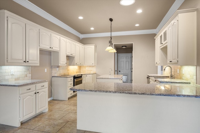 kitchen featuring stainless steel electric stove, stone countertops, white cabinetry, and sink