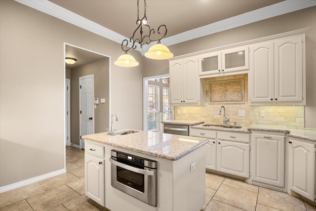 kitchen with sink, decorative light fixtures, a center island with sink, white cabinets, and appliances with stainless steel finishes