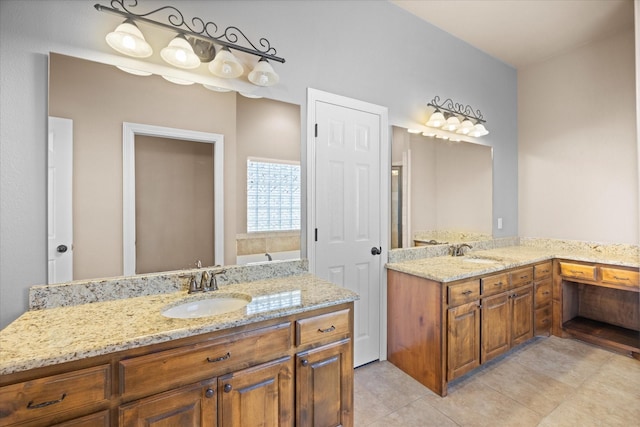 bathroom featuring vanity, tile patterned floors, and a bathing tub