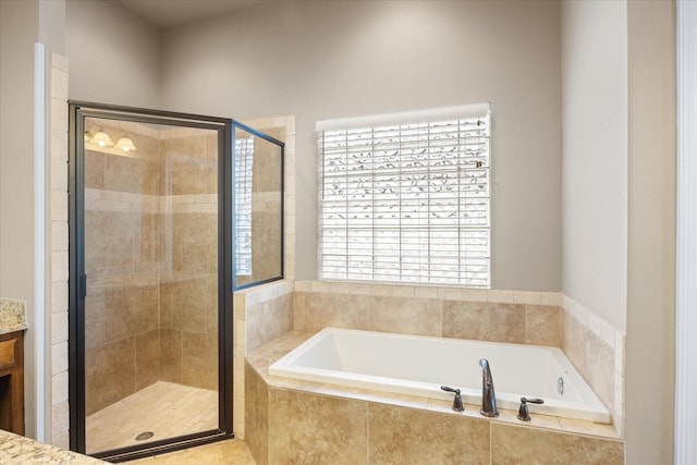 bathroom with vanity and independent shower and bath