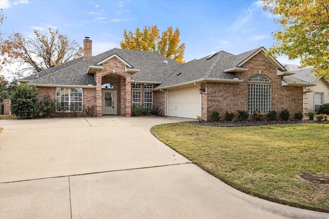 ranch-style house featuring a garage and a front lawn