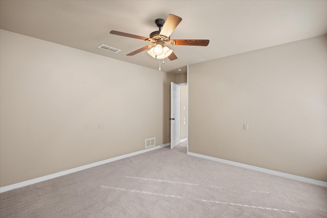 unfurnished room featuring light carpet and ceiling fan