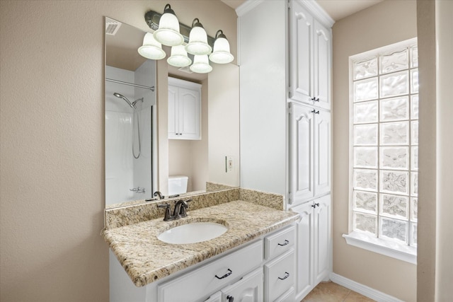 bathroom featuring vanity, toilet, and walk in shower