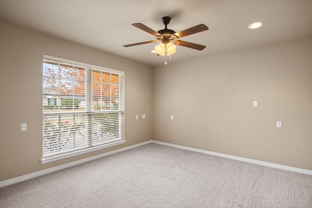 spare room featuring ceiling fan and carpet floors