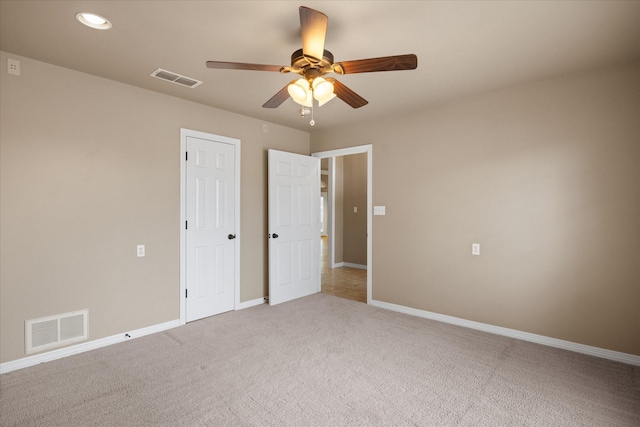 unfurnished bedroom featuring light colored carpet and ceiling fan