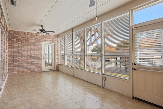 unfurnished sunroom with ceiling fan