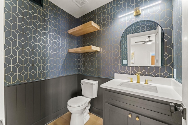 bathroom featuring vanity, ceiling fan, and toilet