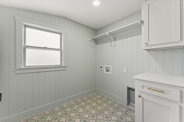 washroom with hookup for an electric dryer, wood walls, cabinets, and hookup for a washing machine