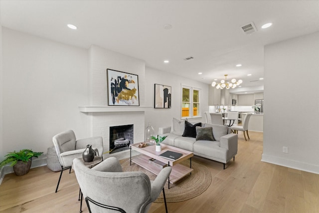 living room featuring a fireplace and light wood-type flooring