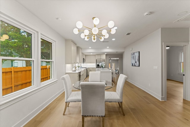 dining room featuring a chandelier and light wood-type flooring