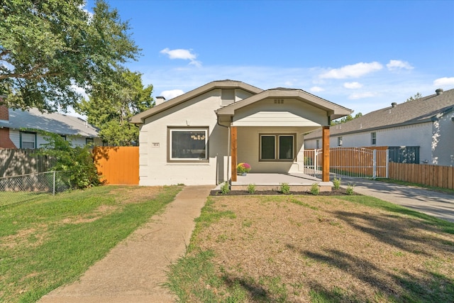 bungalow-style home with a front yard