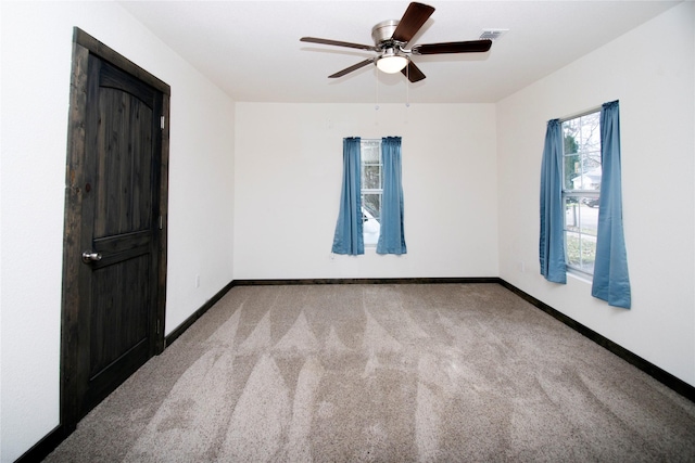 carpeted empty room with ceiling fan