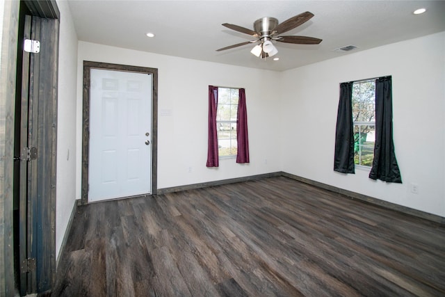 spare room featuring ceiling fan, plenty of natural light, and dark hardwood / wood-style floors