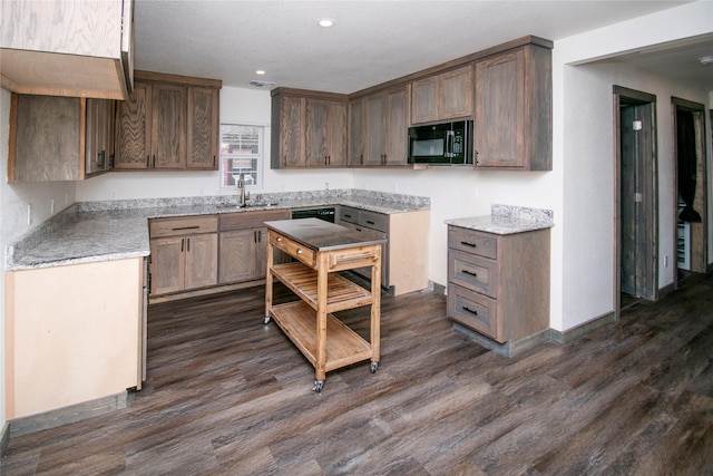 kitchen with sink and dark wood-type flooring