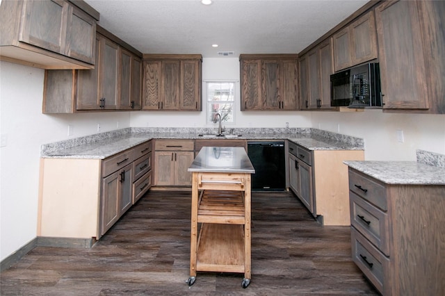 kitchen with sink, a textured ceiling, dark hardwood / wood-style floors, and black appliances