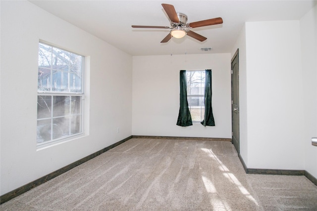 carpeted empty room featuring ceiling fan