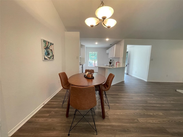 dining area featuring an inviting chandelier and dark hardwood / wood-style flooring