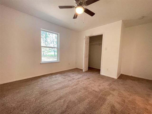 unfurnished bedroom with carpet, a closet, and ceiling fan