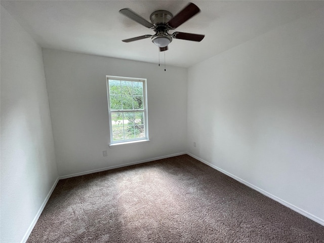 spare room with ceiling fan and carpet