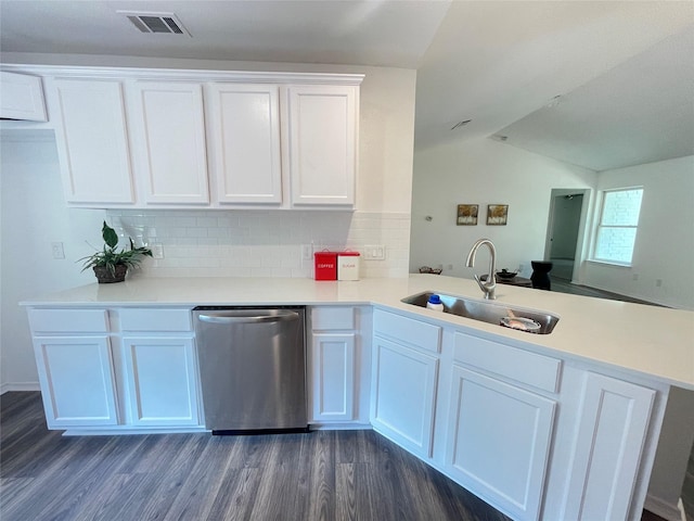 kitchen with dark hardwood / wood-style floors, sink, white cabinets, stainless steel dishwasher, and kitchen peninsula