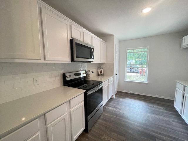 kitchen featuring decorative backsplash, white cabinets, stainless steel appliances, and dark hardwood / wood-style floors