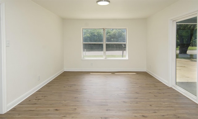 unfurnished room with hardwood / wood-style flooring