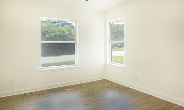 unfurnished room with dark wood-type flooring