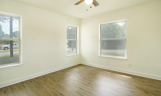 spare room with hardwood / wood-style floors and ceiling fan