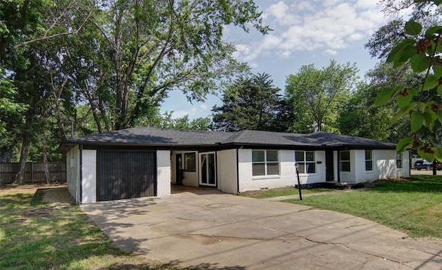 ranch-style house with a garage and a front lawn