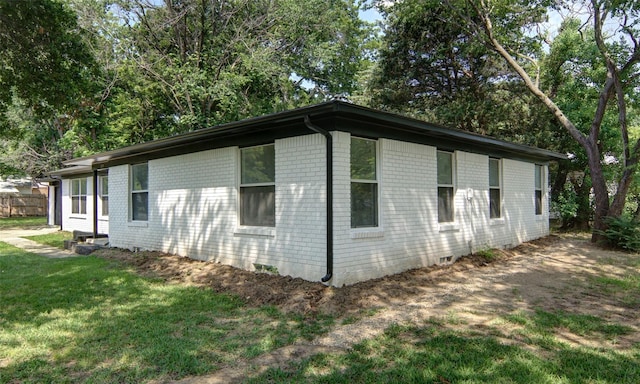 view of property exterior with a lawn