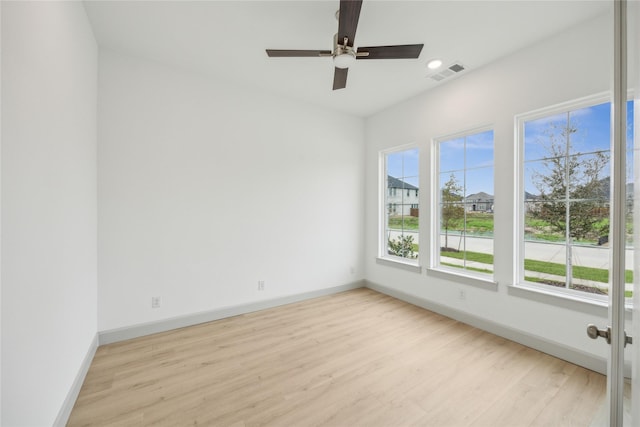 spare room featuring ceiling fan and light wood-type flooring