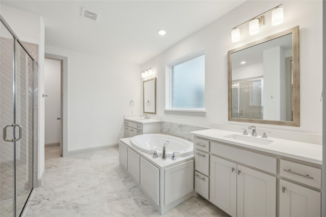 bathroom with vanity and independent shower and bath