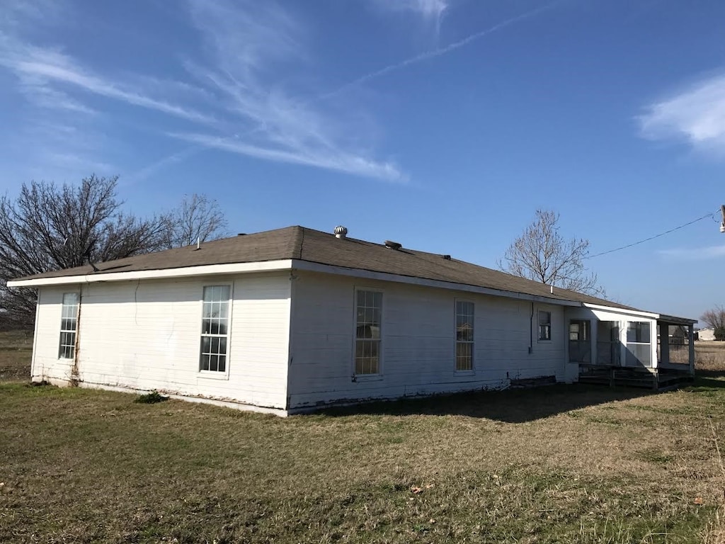 view of property exterior featuring a lawn