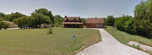 view of front facade featuring a garage and an outbuilding