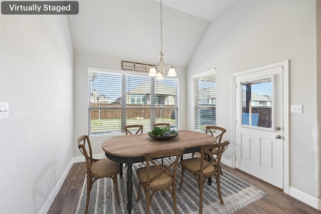 dining room with lofted ceiling and a chandelier