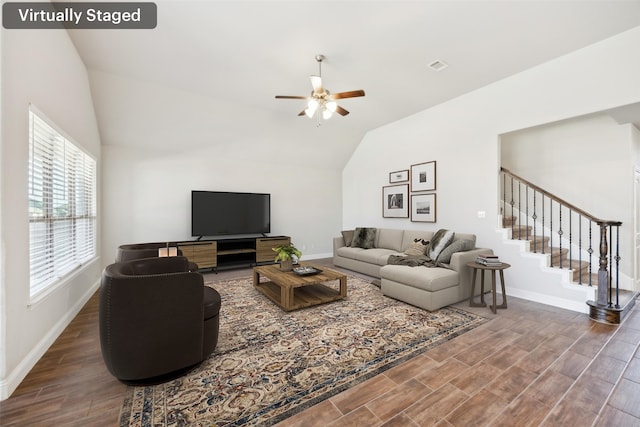 living room featuring lofted ceiling, dark hardwood / wood-style floors, and ceiling fan